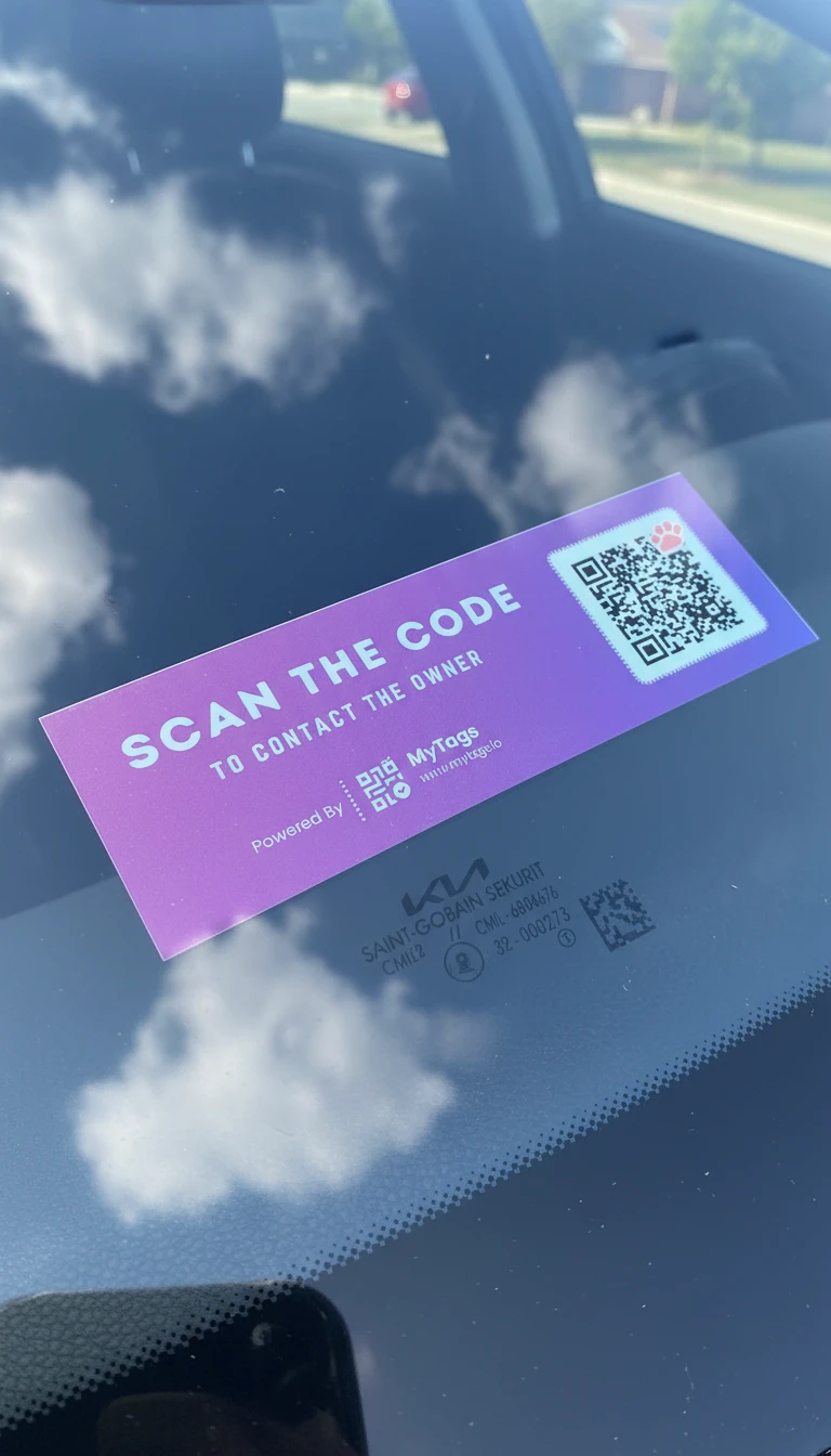 A MyTags contact sticker on a car windshield